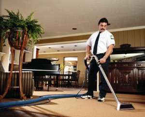 Technician cleaning the carpet in a Dallas home. Carpet in Dallas home getting getting professionally cleaned.